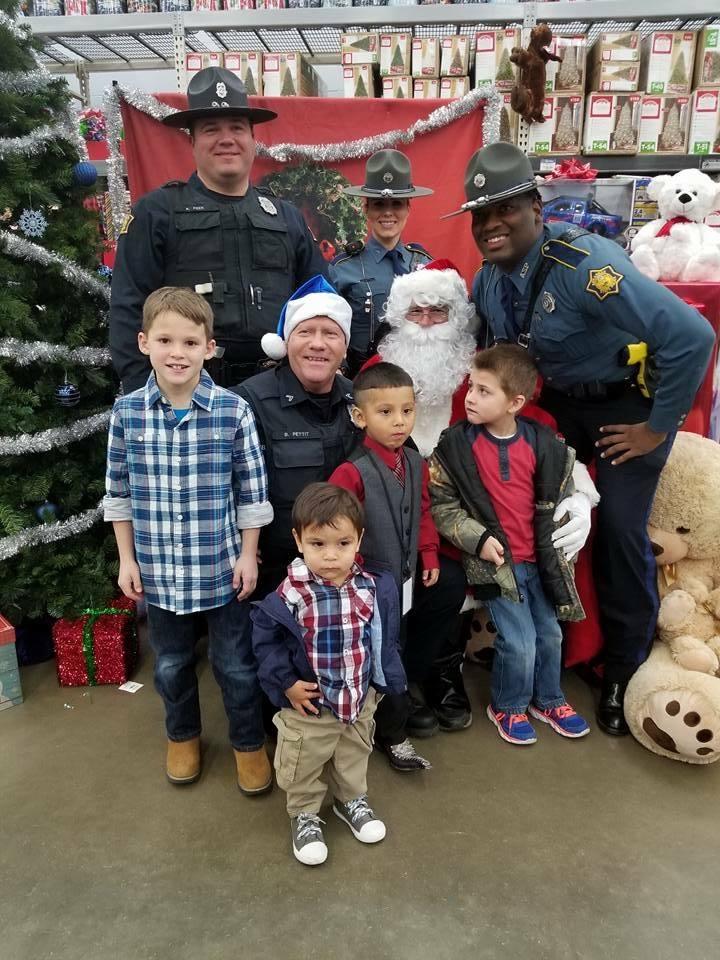 Sheriff's Office staff and young children sitting with Santa