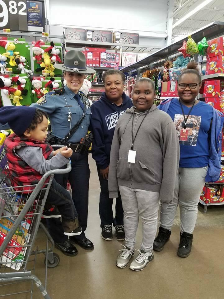 Law Enforcement officer shopping with a family in Walmart
