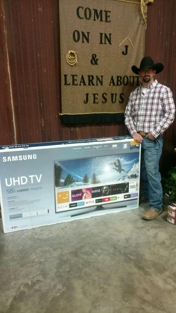 Deputy Michael standing next to 58" UHD TV box