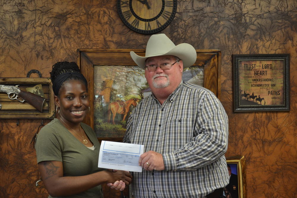 Andrea Hale receiving check from Sheriff Singleton